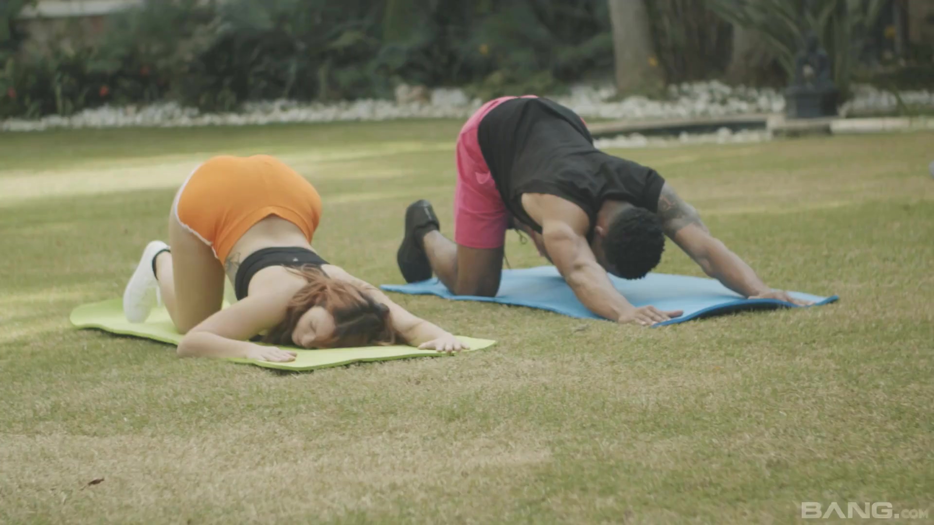 Una pelirroja de ojos azules sonriendo ante la BBC después de una romántica sesión de yoga.